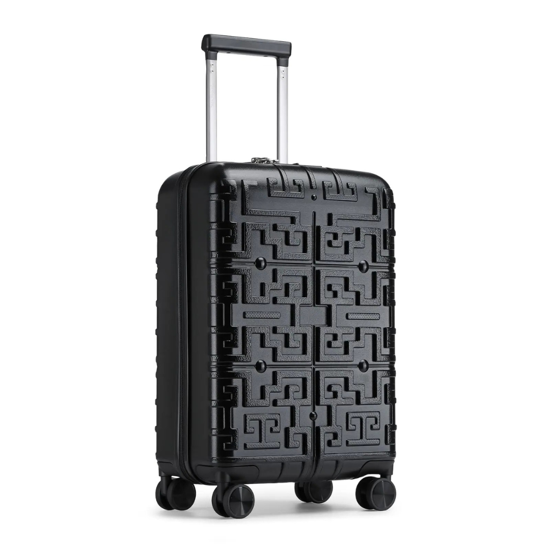 Valise rigide noire avec motif géométrique en relief, équipée d’une poignée télescopique et de 4 roues pivotantes 360° pour un transport facile et fluide.